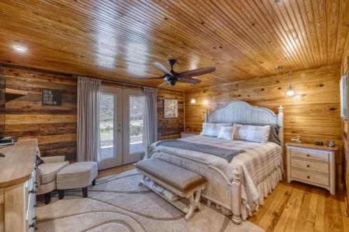 a bedroom with a bed and a ceiling fan at Frio Hills Hideaway in Leakey