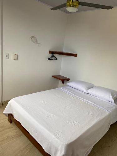 a white bed in a room with a ceiling at Rosablanca RN in Guaduas