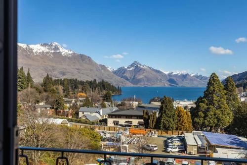 a view of a town with a lake and mountains at Ballarat Bungalow in Queenstown