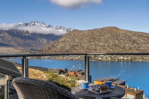 a balcony with a table and a view of a mountain at Bluewater Views in Queenstown