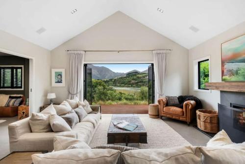a living room with a couch and a fireplace at The Stowaway in Queenstown