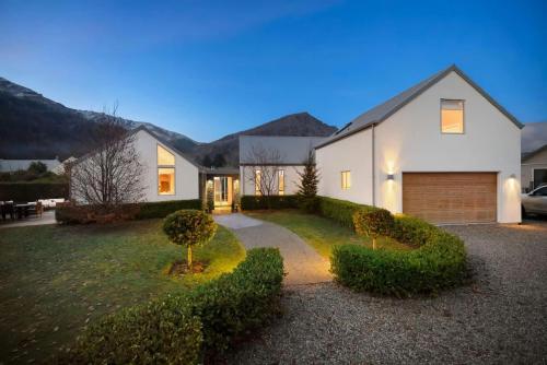 a large white house with a driveway at Glebe Arrowtown in Arrowtown