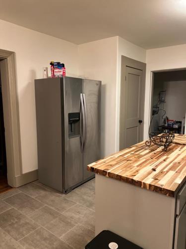 a kitchen with a stainless steel refrigerator and a counter at Luna Luxury - 2BR near VCU & Richmond Raceway in Richmond