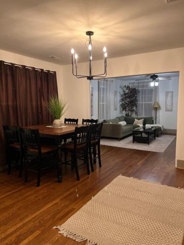 a dining room and living room with a table and chairs at Luna Luxury - 2BR near VCU & Richmond Raceway in Richmond