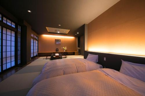 a bedroom with two beds in a room at New Ogiya in Fukushima