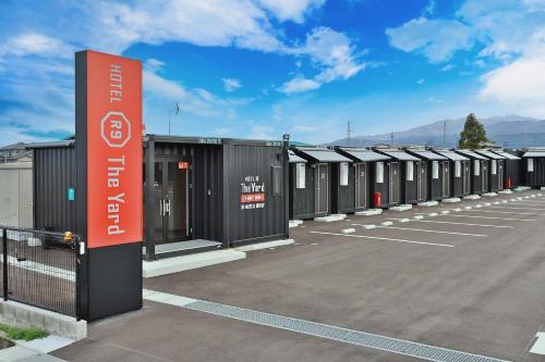 a row of portable toilets in a parking lot at HOTEL R9 The Yard Kamiichi in Kamiichi
