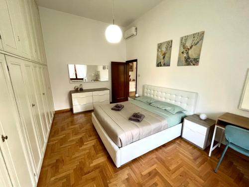 a bedroom with a bed and a desk in it at Florence Lungarno Apartment in Florence
