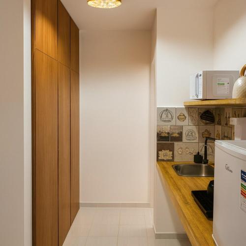 a kitchen with a sink and a counter top at Studio Privativo aprox 2,7 km Centro, Praia Clube c Ar Condicionado in Uberlândia