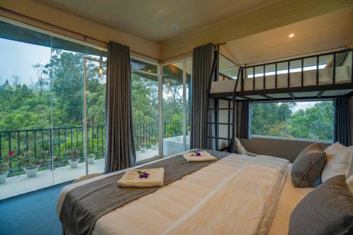 a bedroom with a large bed and a large window at Lavee Villa Ella in Ella