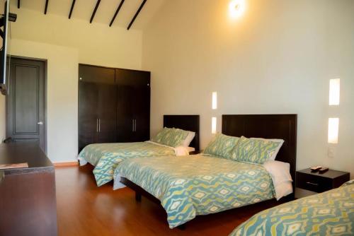 Кровать или кровати в номере Hotel Campestre Casa de la Abuela