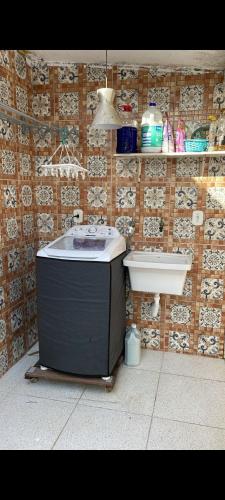 a bathroom with a bath tub next to a toilet at Maitinga, a little paradise in Bertioga