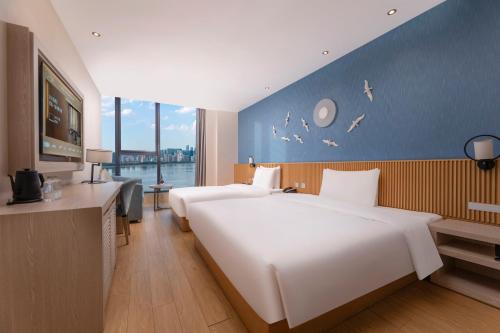 Postel nebo postele na pokoji v ubytování Crystal Orange Hotel (Hangzhou Binjiang Star Avenue)