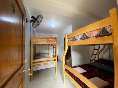 a room with two bunk beds and a door at Tierra y Mar in Montañita