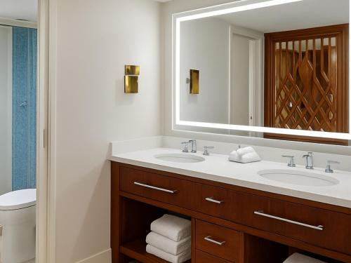a bathroom with two sinks and a large mirror at Sheraton Kauaʻi Resort Villas- STUDIO in Koloa