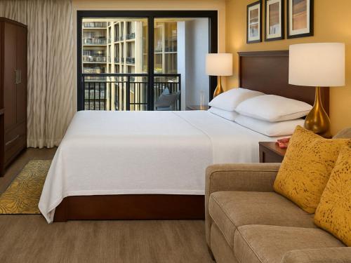 a hotel room with a bed and a couch at Sheraton Kauaʻi Resort Villas- STUDIO in Koloa