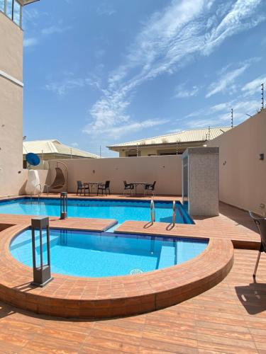 a large swimming pool on top of a building at Glovis Hospitality in Abuja