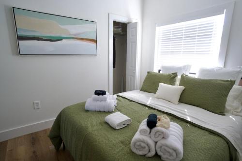 a bedroom with a bed with towels on it at Casa De Ybor 3Bd, 2Bth, 4 beds, Historic Charm, Modern Lux in Tampa