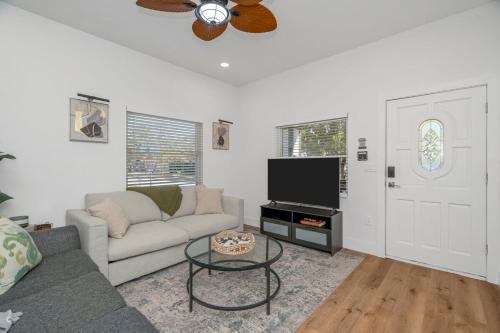 a living room with a couch and a flat screen tv at Casa De Ybor 3Bd, 2Bth, 4 beds, Historic Charm, Modern Lux in Tampa