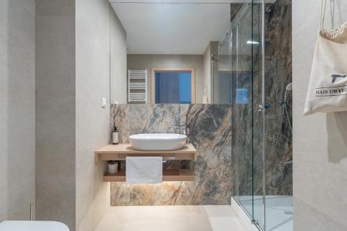 a bathroom with a sink and a shower at Hidden Coast - Premium Seaside Apartments with Pool, 2-Minute Walk to the Beach in Łukęcin
