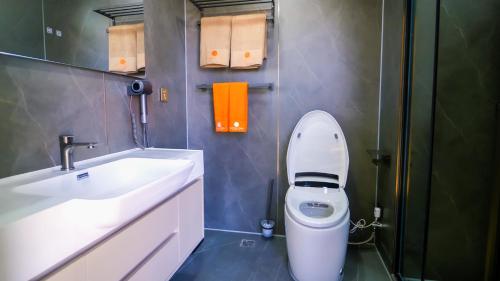 a bathroom with a white toilet and a sink at Tegri Gobi Resort 