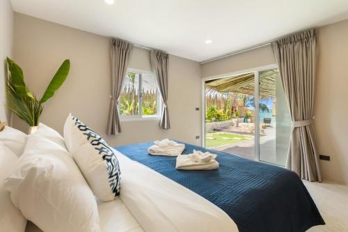 a bedroom with a bed with two towels on it at Little Me Beachfront Villa in Nathon Bay