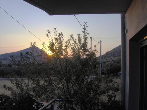 a view of the sunset from the window of a house at Sunset at Cape Sounio in Sounio