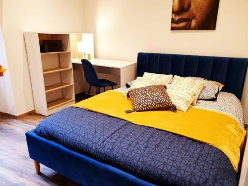 a blue bed with pillows on it in a room at Le saphire St Affrique hyper centre ville in Saint-Affrique