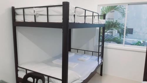 a black bunk bed in a room with a window at Avana Hills Boracay Prime Traveler's Suite 302 in Boracay