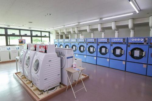 a laundry room with blue and white washing machines at Hotel Angel Grandia Echigo Nakazato in Yuzawa