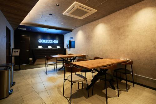 a restaurant with tables and chairs in a room at B/C HOTEL NAHA Hotel with Rental Car in Naha