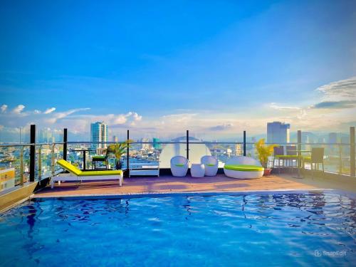 a swimming pool on the roof of a building at Roliva Hotel & Apartment Danang in Da Nang