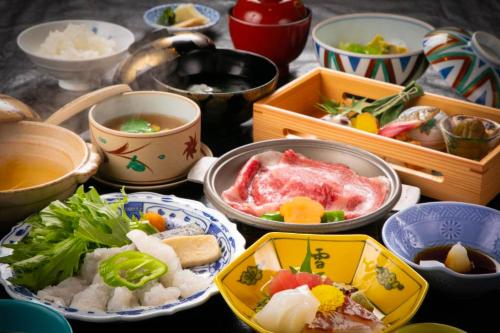 a table topped with bowls of food and other dishes at Ohanabo in Kyoto
