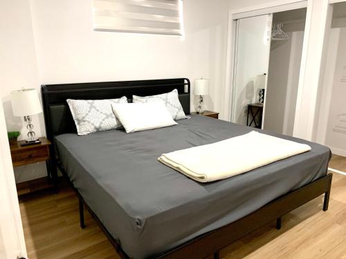 a bed with two pillows on it in a bedroom at Royal Oak in Winnipeg