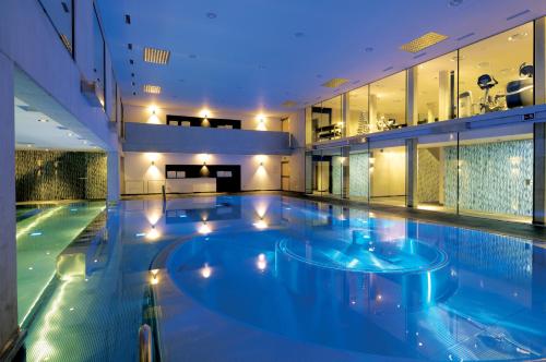 a large swimming pool in a building at Alpenlove - Adult SPA Hotel in Seefeld in Tirol