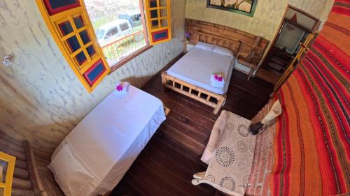 an overhead view of a room with a bed and a table at Típica in Pijao