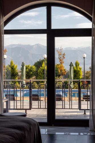 a view of a pool from a bedroom window at Panorama Kakheti Resort in Gurjaani