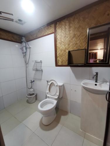 a bathroom with a toilet and a sink at Kimura Beachfront Villas El Nido in El Nido