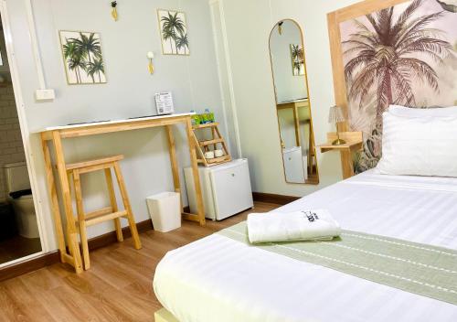 a room with two beds and a mirror at Secret Palm in Ko Phangan