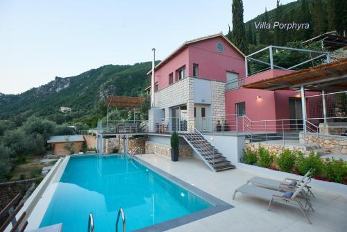 a villa with a swimming pool and a house at Arenaria L. Villas Complex in Lefkada Town