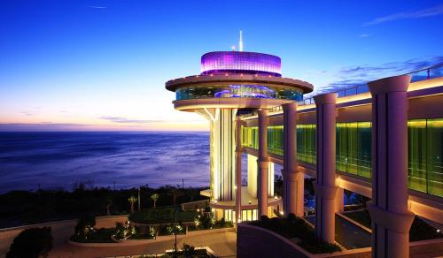 a view of a building with a tower at night at H Resort in Checheng