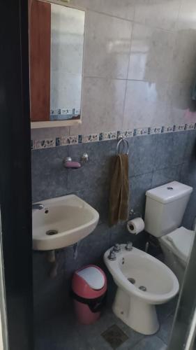 a bathroom with a sink and a toilet and a mirror at Complejo Hudson 60 in Ranelagh