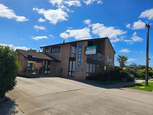 a building with a sign on the front of it at Majestic Motel in Horsham