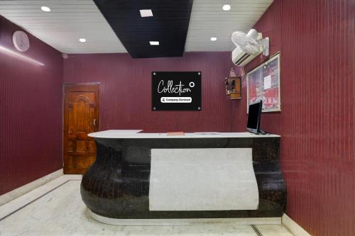 a restaurant with a counter in a red wall at Super Collection O Chhapra Railway Junction Formerly Hotel City Palace in Chupra