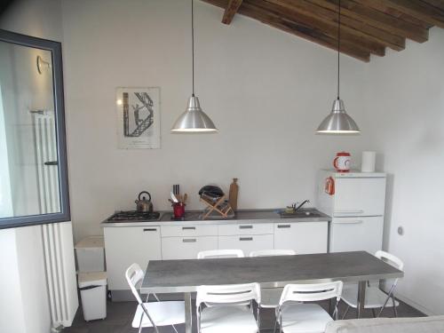 a kitchen with a table and chairs in it at La Crisalide in Sorano