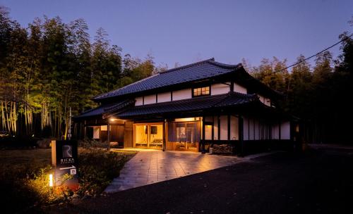 a japanese house with a pathway leading to it at RICKA Katsuura in Katsuura