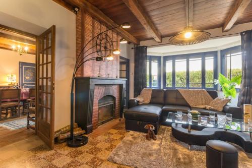 a living room with a couch and a fireplace at les gites du verger in Recey-sur-Ource