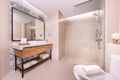 a bathroom with a sink and a shower at M Social Resort Penang in George Town