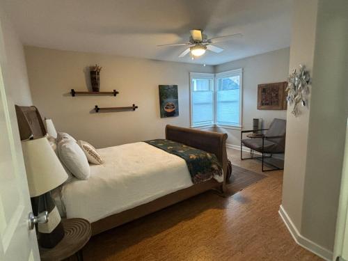 a bedroom with a bed and a ceiling fan at Mississippi waterfront getaway-Dogs Welcome! in Brownsville