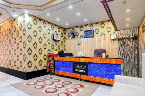 a restaurant with a blue counter with a counter at Collection O by OYO NSCB International Airport Formerly Raj Guest House in Salua