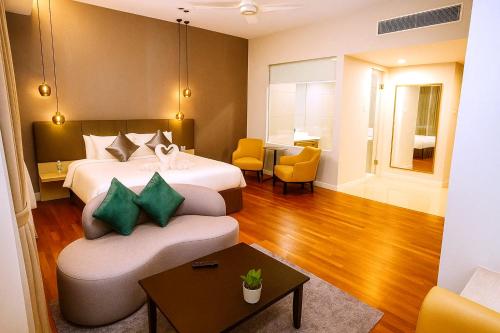 a hotel room with a bed and a couch at Cormar Suites Kuala Lumpur in Kuala Lumpur